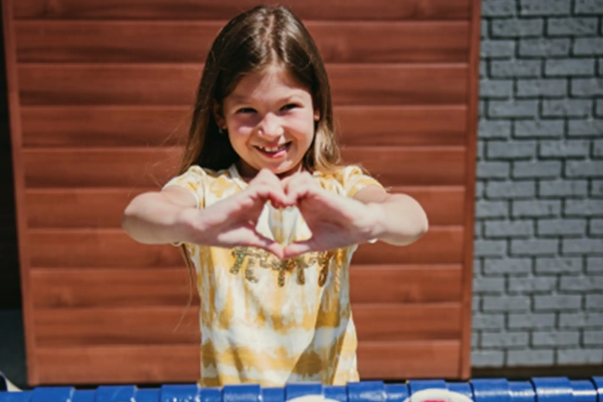 Girl showing with heart sign 